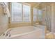 Bright bathroom showcasing a soaking tub and separate glass-enclosed shower at 505 Chamberlain Ct, Mcadenville, NC 28101