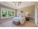 Bright Primary bedroom with tray ceiling, large windows, and backyard views at 505 Chamberlain Ct, Mcadenville, NC 28101