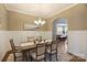 Bright dining room with classic wainscoting, chandelier, and view to a separate room at 505 Chamberlain Ct, Mcadenville, NC 28101