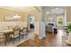 Open-concept dining room adjacent to a bright living room, showcasing hardwood floors at 505 Chamberlain Ct, Mcadenville, NC 28101