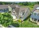 Aerial of a well-maintained home with green lawn, mature trees, and neighboring houses at 505 Chamberlain Ct, Mcadenville, NC 28101
