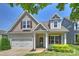 Charming home featuring a two-car garage, covered entryway, and manicured landscaping at 505 Chamberlain Ct, Mcadenville, NC 28101