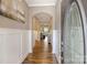 Inviting foyer featuring hardwood floors, elegant wainscoting, and an arched entryway into the living spaces at 505 Chamberlain Ct, Mcadenville, NC 28101