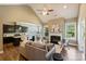 Open-concept living area with vaulted ceiling, fireplace, and view into kitchen and dining spaces at 505 Chamberlain Ct, Mcadenville, NC 28101