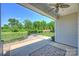 Covered patio featuring ceiling fan with view of backyard fire pit and manicured landscaping at 505 Chamberlain Ct, Mcadenville, NC 28101