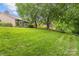 Expansive backyard featuring a well-manicured lawn and mature trees, offering privacy at 5306 Sandtrap Ln, Charlotte, NC 28226