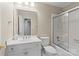 Bright bathroom featuring a glass shower door, a white vanity with starfish decor, and neutral wall paint at 5306 Sandtrap Ln, Charlotte, NC 28226