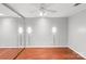 Bedroom features mirrored closet, hardwood flooring, ceiling fan and recessed lighting at 5306 Sandtrap Ln, Charlotte, NC 28226
