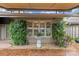 Charming courtyard featuring brick pavers, manicured greenery, an awning, and elegant outdoor decor at 5306 Sandtrap Ln, Charlotte, NC 28226
