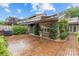 Inviting brick courtyard with manicured hedges, flowers, and outdoor entertaining space at 5306 Sandtrap Ln, Charlotte, NC 28226