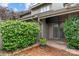 Attractive home featuring lush greenery, mature landscaping, a bricked yard, and an awning-covered entry at 5306 Sandtrap Ln, Charlotte, NC 28226