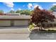 Charming home showcasing a two-car garage and a beautifully landscaped yard with a vibrant maple tree at 5306 Sandtrap Ln, Charlotte, NC 28226
