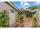 Inviting side entrance to a charming home with a brick walkway and well-maintained landscaping at 5306 Sandtrap Ln, Charlotte, NC 28226