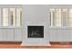 Living room fireplace with marble surround and custom built-in shelving and cabinets at 5306 Sandtrap Ln, Charlotte, NC 28226