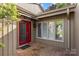Welcoming front entrance with red door, brick pathway, and ample natural light from large windows at 5306 Sandtrap Ln, Charlotte, NC 28226