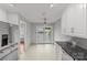 Open kitchen with tile flooring, stainless steel appliances, and sliding glass door to the outdoor patio at 5306 Sandtrap Ln, Charlotte, NC 28226