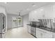 Spacious kitchen with stainless steel appliances, black countertops, and a sliding glass door to the backyard at 5306 Sandtrap Ln, Charlotte, NC 28226
