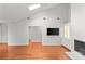 Open-concept living room with vaulted ceiling, fireplace, hardwood floors, and built-in cabinets at 5306 Sandtrap Ln, Charlotte, NC 28226
