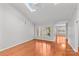Bright living room featuring hardwood floors, skylight, and large windows at 5306 Sandtrap Ln, Charlotte, NC 28226
