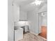 Close up of office space with built-in desk, cabinets, and a view into the bedroom at 5306 Sandtrap Ln, Charlotte, NC 28226