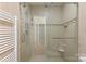 Modern shower stall with glass door, tiled walls, and a built-in seat at 5306 Sandtrap Ln, Charlotte, NC 28226