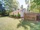 The backyard shows the home's exterior, lawn, and a partial fence with plants visible at 610 N Pine Ln, Wadesboro, NC 28170
