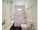 Bathroom featuring a vanity sink, soaking tub, shower combo, and toilet at 610 N Pine Ln, Wadesboro, NC 28170