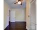Cozy bedroom featuring hardwood floors, ceiling fan, and closet space at 610 N Pine Ln, Wadesboro, NC 28170