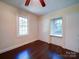 Sun-filled bedroom featuring hardwood floors, two windows, and closet space at 610 N Pine Ln, Wadesboro, NC 28170