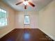 Bedroom featuring dark hardwood floors, neutral walls, and two closets with bi-fold doors at 610 N Pine Ln, Wadesboro, NC 28170