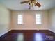 Bedroom with hardwood floors, neutral-toned walls, and a ceiling fan providing comfort at 610 N Pine Ln, Wadesboro, NC 28170
