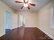 Bedroom boasting natural light, hardwood floors, ceiling fan, and closet at 610 N Pine Ln, Wadesboro, NC 28170