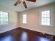 Bedroom featuring gleaming hardwood floors, white trim, and two windows to let in plenty of natural light at 610 N Pine Ln, Wadesboro, NC 28170