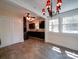 Open dining area with tiled floors, modern chandelier, and adjacent kitchen with dark cabinets at 610 N Pine Ln, Wadesboro, NC 28170