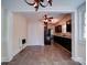 Open dining area with tiled floors leading into a kitchen with dark cabinetry and updated appliances at 610 N Pine Ln, Wadesboro, NC 28170
