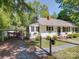 Exterior view featuring a charming home with a carport and manicured landscaping at 610 N Pine Ln, Wadesboro, NC 28170