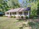 Charming home with a manicured front yard, mature trees, and a cozy porch at 610 N Pine Ln, Wadesboro, NC 28170