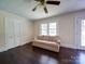 Bright living room with hardwood floors, a ceiling fan, and classic white trim throughout the space at 610 N Pine Ln, Wadesboro, NC 28170