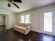Cozy living room featuring dark hardwood floors, a ceiling fan, and a comfortable sofa for relaxing at 610 N Pine Ln, Wadesboro, NC 28170