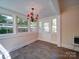 Bright sunroom featuring tiled flooring, large windows and a red chandelier for a cozy feel at 610 N Pine Ln, Wadesboro, NC 28170