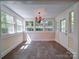 Sunroom with tiled floors, neutral paint, large windows, and an airy ambiance at 610 N Pine Ln, Wadesboro, NC 28170