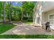 Large backyard with brick patio, fire pit, mature trees and a well maintained lawn at 6101 Park Hill Rd, Charlotte, NC 28277