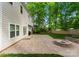 Beautiful backyard with a brick patio, a stone fire pit, and a lush lawn at 6101 Park Hill Rd, Charlotte, NC 28277