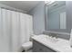 Bathroom with grey vanity, marble countertop, and shower with white patterned curtain at 6101 Park Hill Rd, Charlotte, NC 28277