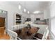 The dining area has a dark wood table with white chairs, modern lighting, and wood floors at 6101 Park Hill Rd, Charlotte, NC 28277