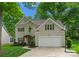 Charming two-story home with attached garage and landscaped front yard is surrounded by mature trees at 6101 Park Hill Rd, Charlotte, NC 28277