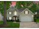 Charming two-story home featuring a well-manicured lawn, two-car garage and inviting front porch at 6101 Park Hill Rd, Charlotte, NC 28277