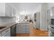 Open concept kitchen featuring stainless steel appliances, granite counters and seamless transition to living area at 6101 Park Hill Rd, Charlotte, NC 28277