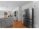 Open kitchen with stainless steel refrigerator and view into living area at 6101 Park Hill Rd, Charlotte, NC 28277