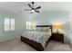 Cozy main bedroom with vaulted ceiling, ceiling fan, queen-sized bed, and shuttered window at 6101 Park Hill Rd, Charlotte, NC 28277